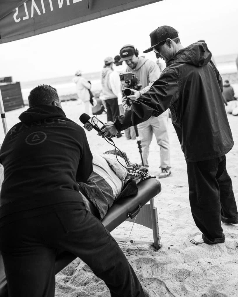 Range Sports Therapy treating an athlete at a surf event